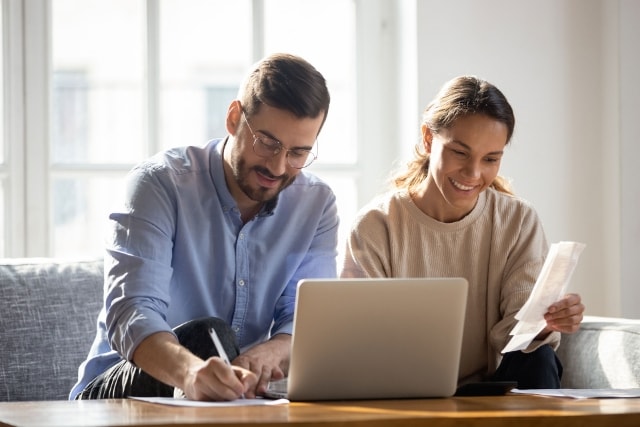 Couple looking at payment notifications on computer