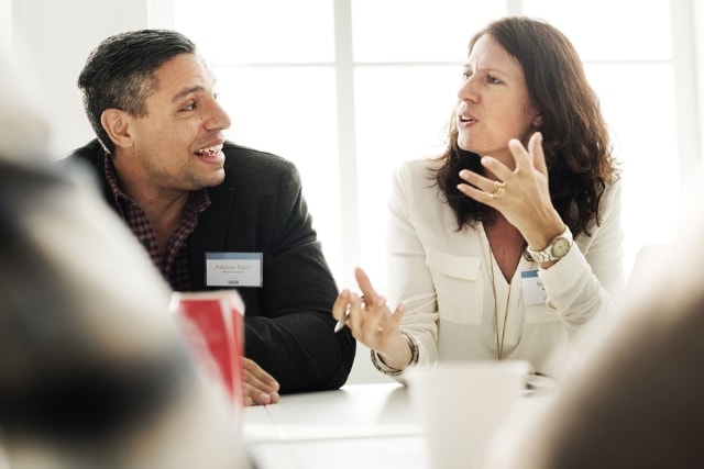 Two people talking in a meeting