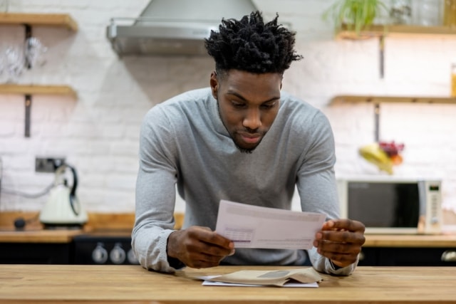 Man reading a notification letter